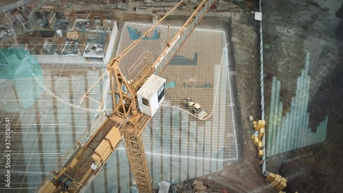 Yellow crane in construction site with statistical graphics animation for production trend and control of workers team. Potential investiment income calculator. Aerial drone footage photo