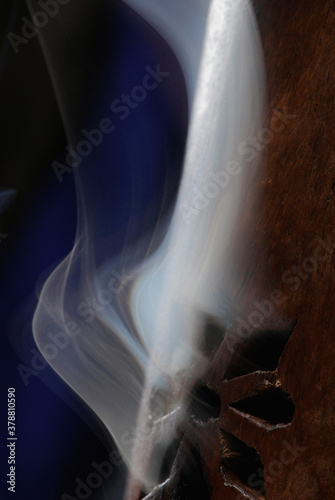 Close-up of smoke rising out of a wooden cylinder