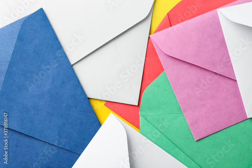 Colorful paper envelopes as background, top view
