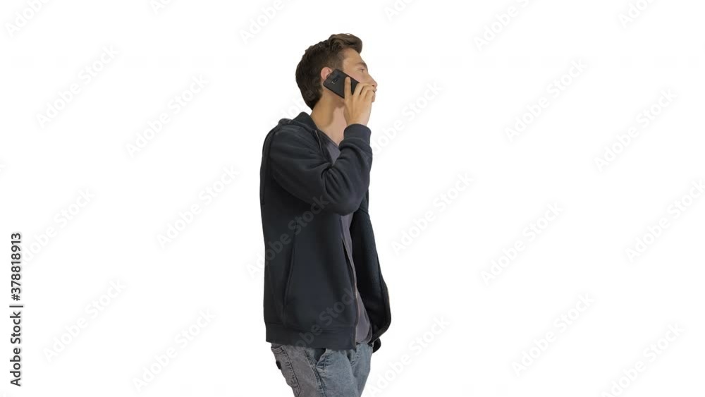 Casual man talking on mobile phone while walking on white background. Casual man talking on mobile phone while walking on white background.