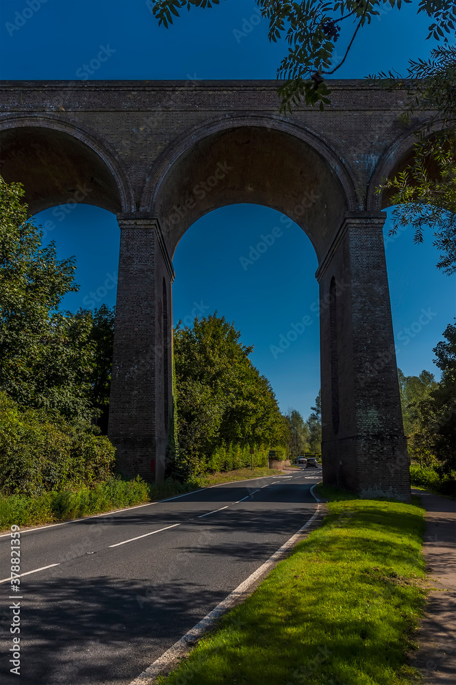 A view of the road passing underneath the Chappel Viaduct near Colchester, UK in the summertime