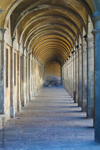 Ancient portico and bicycles in Lucca, Italy