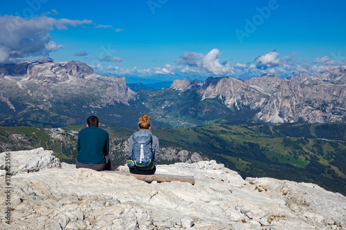 A young couple admires a wonderful panorama in the Italian Alps