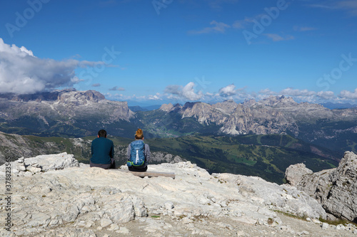 Young couple admiring a wonderful panorama in the Italian Alps
