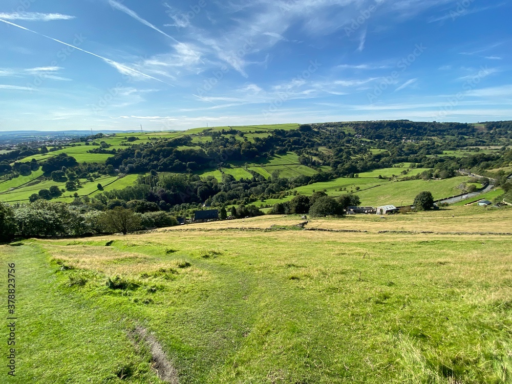 Landscape view, from Brow Lane, over the valley of Shibden, with trees, farms, and meadows, on a sunny day near, Halifax, Yorkshire, UK