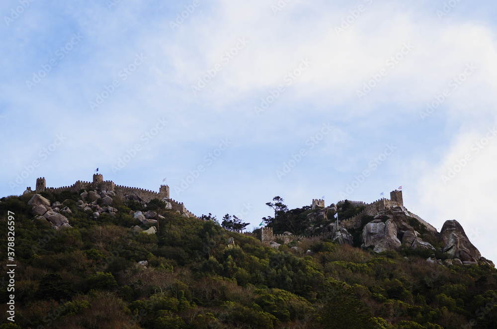 distant view of Castelo dos Mouros (the moorish castle), ancient ruined medieval fortress on the hilltop over the town of Sintra, near Lisbon, Portugal