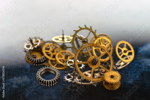 A bunch yellow metal gears of various sizes. Selective focus. © vladk213
