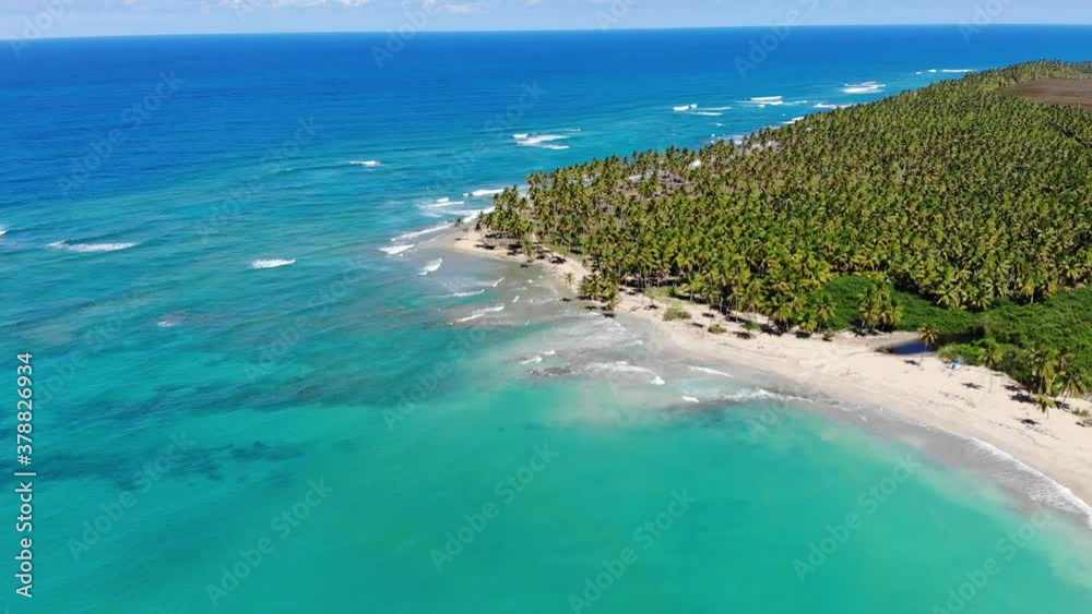 Aerial drone panoramic fly over the paradise beach with palm trees and blue water of Atlantic Ocean El Limon, Miches, Dominican Republic Aerial drone panoramic fly over the paradise beach with palm trees and blue water of Atlantic Ocean El Limon, Miches, Dominican Republic