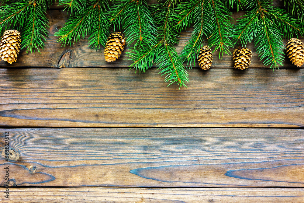 Christmas frame with fir branches, cones, on a dark wooden table. Top view with space for text Christmas frame with fir branches, cones, on a dark wooden table. Top view with space for text