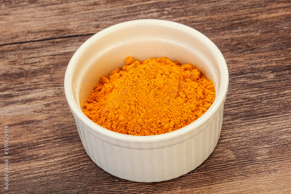 Tumeric powder in the bowl Tumeric powder in the bowl