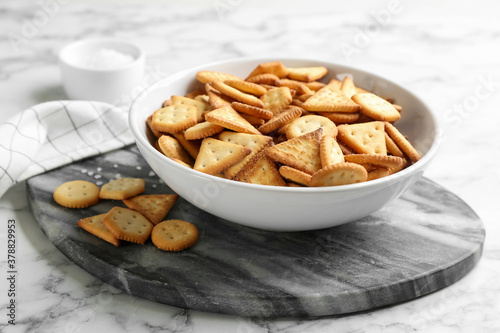 Delicious crispy crackers on white marble table