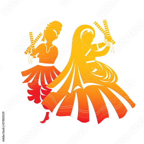 Beautiful Couple dancing with dandiya on celebration of navratri festival of india.