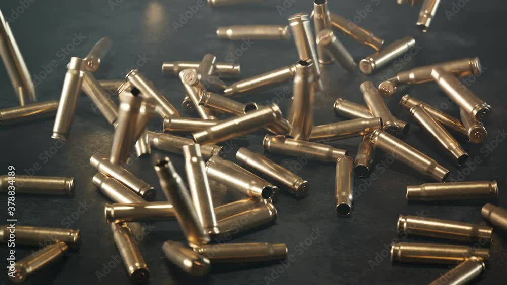 Empty shells falling down on the floor. Gun ammunition. Metal bullets. Ammo.