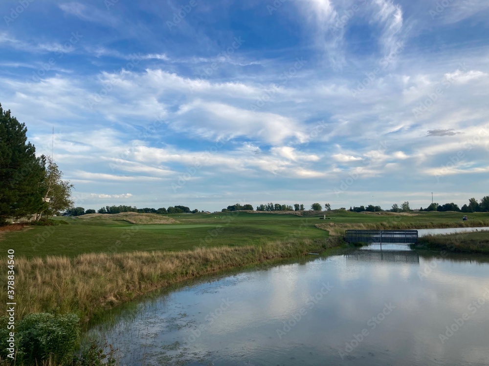 golf course landscape with river and blue sky