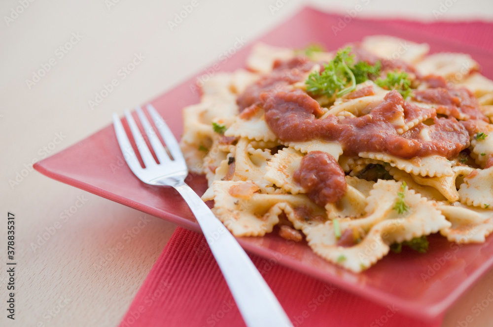 Close-up of pasta in a plate with a fork