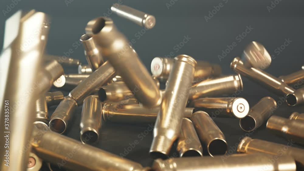 Empty shells falling down on the floor. Gun ammunition. Metal bullets. Ammo.