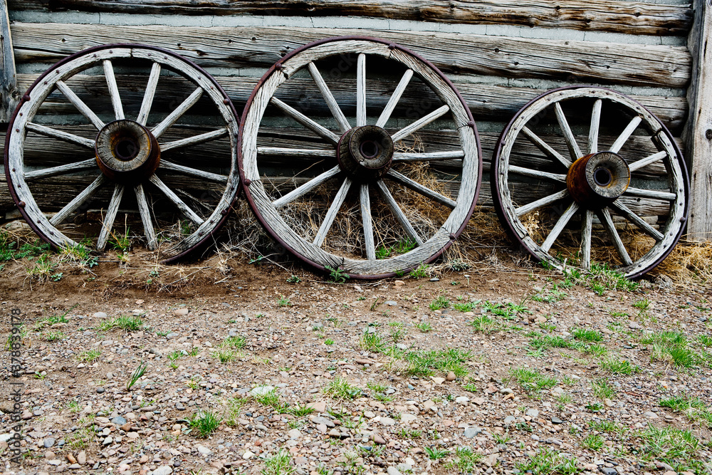 Abandoned wagon wheels in a ghost town, Old Trail Town, Cody, Wyoming, USA