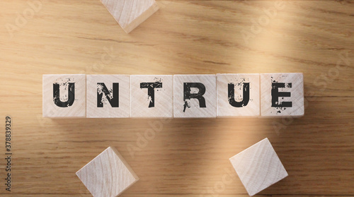 Принти на полотні Untrue word on wooden cubes