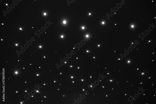 starry night sky mostly black with bright white lights and a starry sky