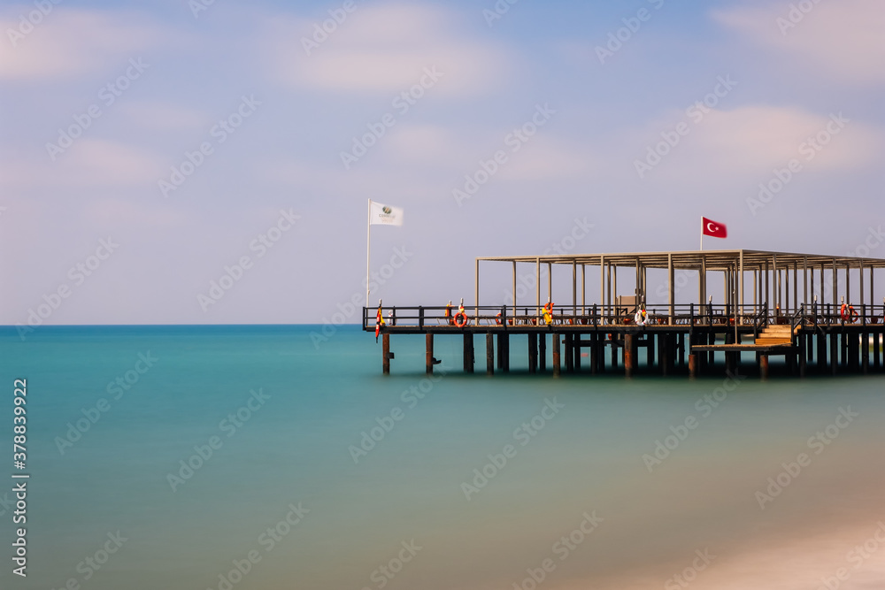 Turkey, Belek. Pier in Mediterranean Sea with long exposure and a blurred background. August 2020