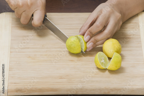 Woman cutting a lemon