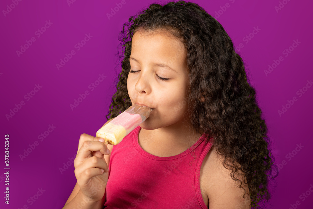 Happy child with toothpick ice cream with lilas background, selective focus. Happy child with toothpick ice cream with lilas background, selective focus.