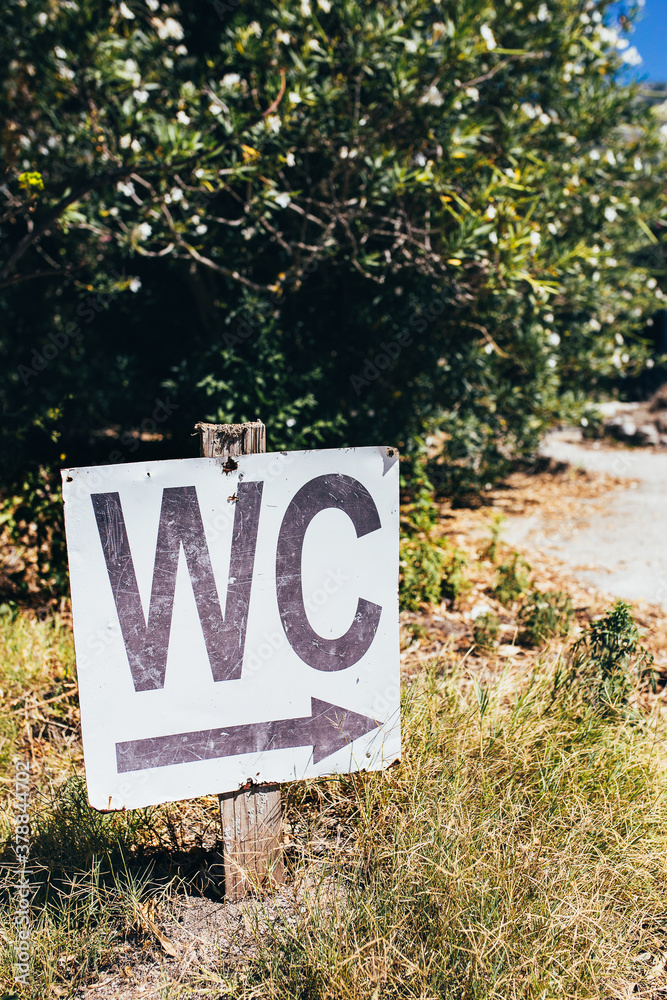 WC sign indicating the direction to the toilet urgent situation Stock Photo Adobe Stock