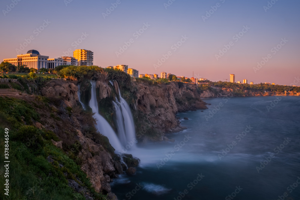 Duden lower waterfalls cascade at sunset in the sea at Antalya, Turkey. July 2020, long exposure picture Duden lower waterfalls cascade at sunset in the sea at Antalya, Turkey. July 2020, long exposure picture