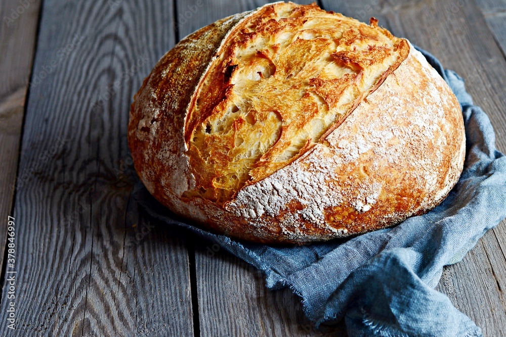 Fresh homemade bread on a gray( blue) background. Crisp French bread. Bread at leaven. Unleavened bread Fresh homemade bread on a gray( blue) background. Crisp French bread. Bread at leaven. Unleavened bread