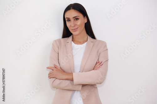 beautiful business lady in suit standing with arms crossed, isolated background