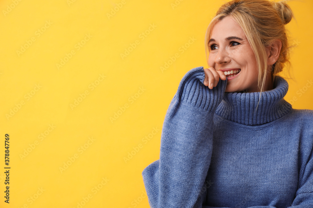Happy woman in stylish sweater on yellow background. Space for text Happy woman in stylish sweater on yellow background. Space for text