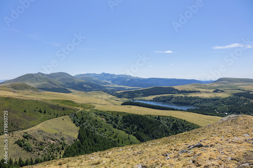 Highland landscapes in Volcans d'Auvergne regional Natural Park with Lac du Guery - highest lake in Auvergne at 1250m altitude. Massif Central, Auvergne-Rhone-Alpes administrative region, France.
