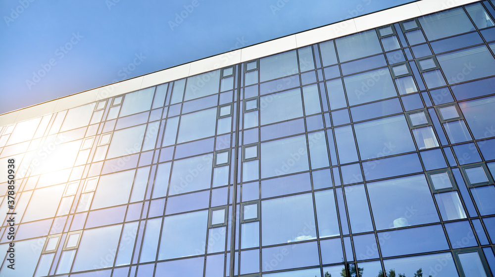 Office building, details of blue glass wall and sun reflections. Office building, details of blue glass wall and sun reflections.