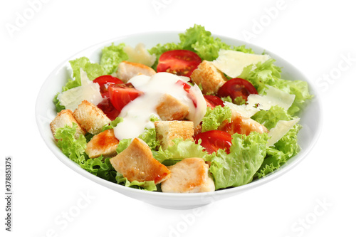 Delicious fresh Caesar salad in bowl on white background
