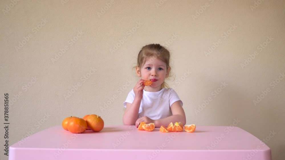 The child is eating a tangerine. Orange and baby. Food for children. Correct and healthy food. Fruits. High quality 4k footage The child is eating a tangerine. Orange and baby. Food for children. Correct and healthy food. Fruits. High quality 4k footage
