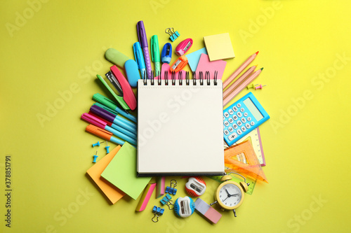 Blank notebook and school stationery on yellow background, flat lay with space for text. Back to school photo