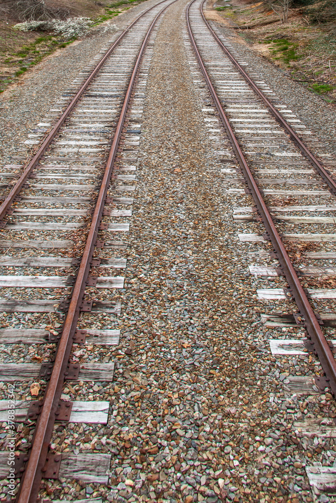 Rusty iron train tracks near a train station