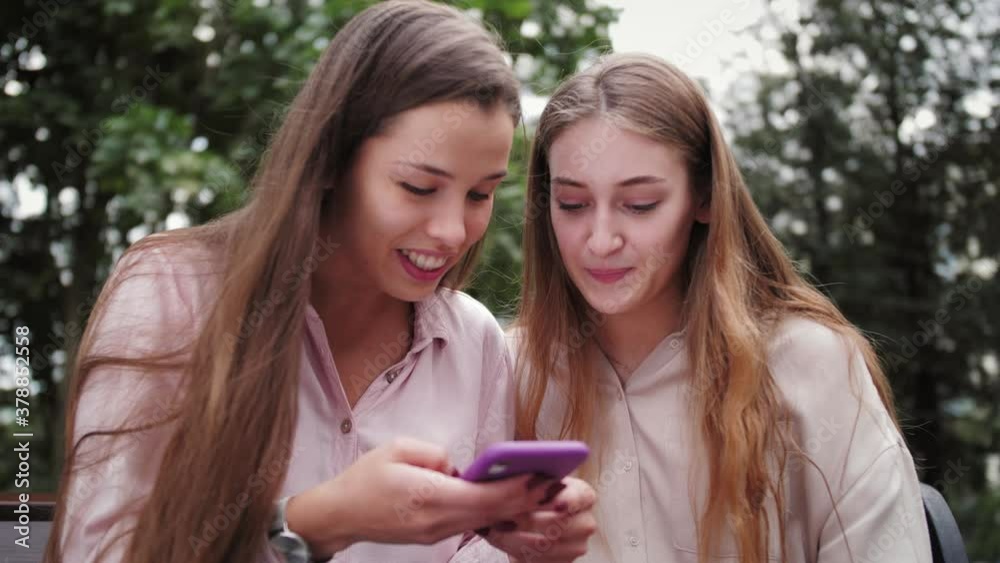 Portraits of happy excited funny women. Girls use smartphone. Surprised ladies celebrating victory. Winner celebrate mobile online bid game win victory success receive read good news on gadget. Portraits of happy excited funny women. Girls use smartphone. Surprised ladies celebrating victory. Winner celebrate mobile online bid game win victory success receive read good news on gadget.