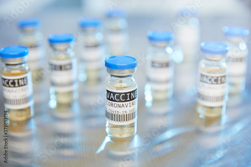 Vászonkép Group of Covid-19 coronavirus vaccine vials in laboratory on stainless steel tab