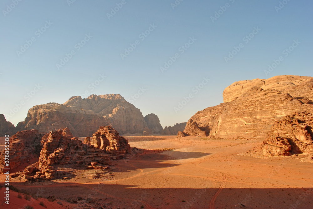 Evening landscape of the Wadi Rum desert. Sandstone rocks and sand valley. Evening landscape of the Wadi Rum desert. Sandstone rocks and sand valley.