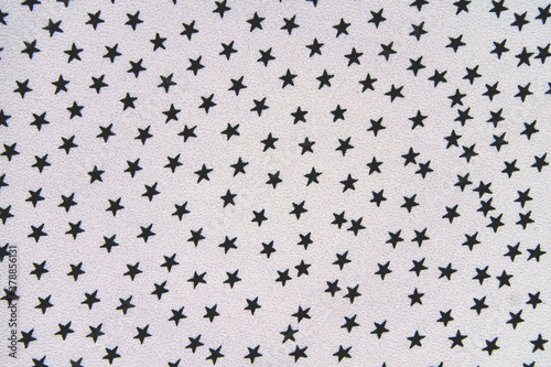 Close-up of black and white pattern fabric. Stars as a background