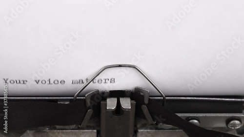 typing a message your voice matters on a vintage typewriter close-up