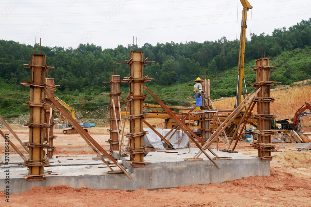 KUALA LUMPUR, MALAYSIA -SEPTEMBER 19, 2020: Column timber form work and reinforcement bar at the construction site. Installed by construction workers. The structure supported by temporary wood support KUALA LUMPUR, MALAYSIA -SEPTEMBER 19, 2020: Column timber form work and reinforcement bar at the construction site. Installed by construction workers. The structure supported by temporary wood support