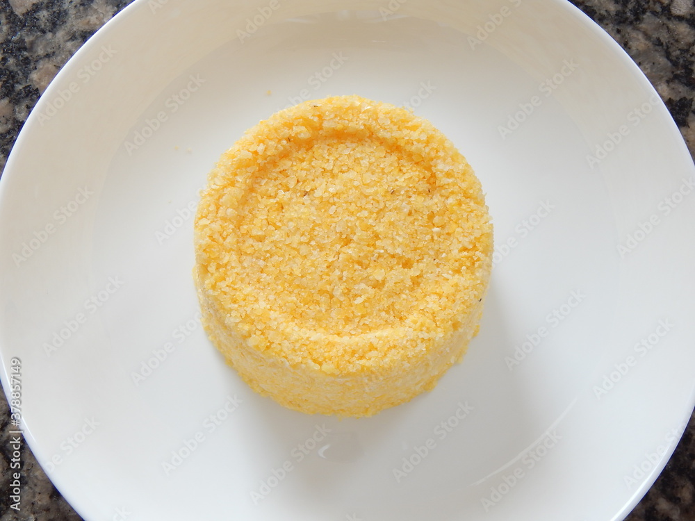 Traditional Brazilian couscous (cuscus/cuscuz). Tropical food. The Brazilian Couscous from the Northeast Region also known as Corn Couscous is a nutritious, cheap and a really simple recipe to make. Traditional Brazilian couscous (cuscus/cuscuz). Tropical food. The Brazilian Couscous from the Northeast Region also known as Corn Couscous is a nutritious, cheap and a really simple recipe to make.