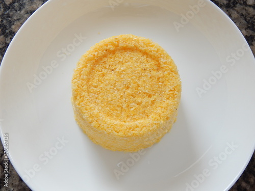 Traditional Brazilian couscous (cuscus/cuscuz). Tropical food. The Brazilian Couscous from the Northeast Region also known as Corn Couscous is a nutritious, cheap and a really simple recipe to make. photo