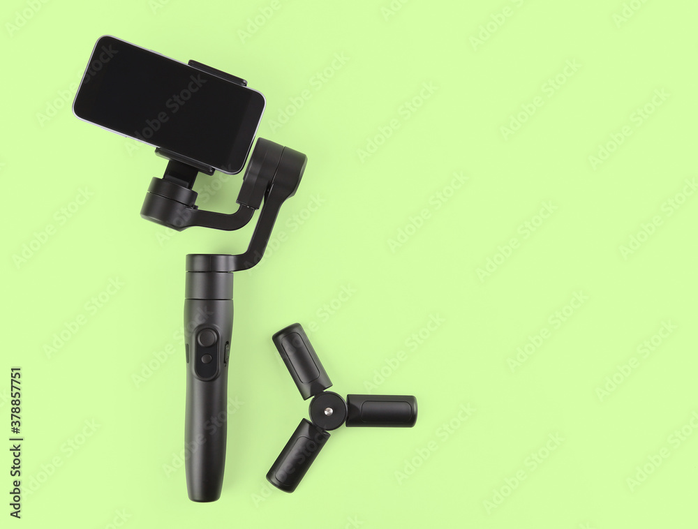 Gimbal. Stabilizer for cellphone on green background
