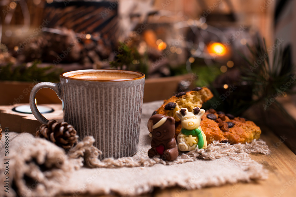 Mug of cocoa with chocolate chip cookies on a wooden table. Christmas drink and biscuit, festive decoration with garlands. Retro photo Happy New Year. High quality photo