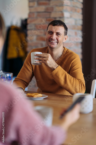 A couple having breakfast and drinking coffee