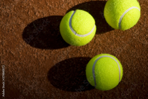 Close-up of three tennis balls in a court 