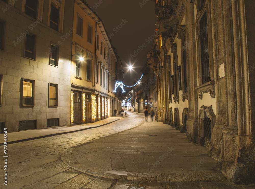 Deserted street with Xmas lights. Christmas city decorations. Festive illumination in Milan center.Italy